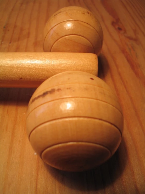 two wooden hammers resting on a wooden table