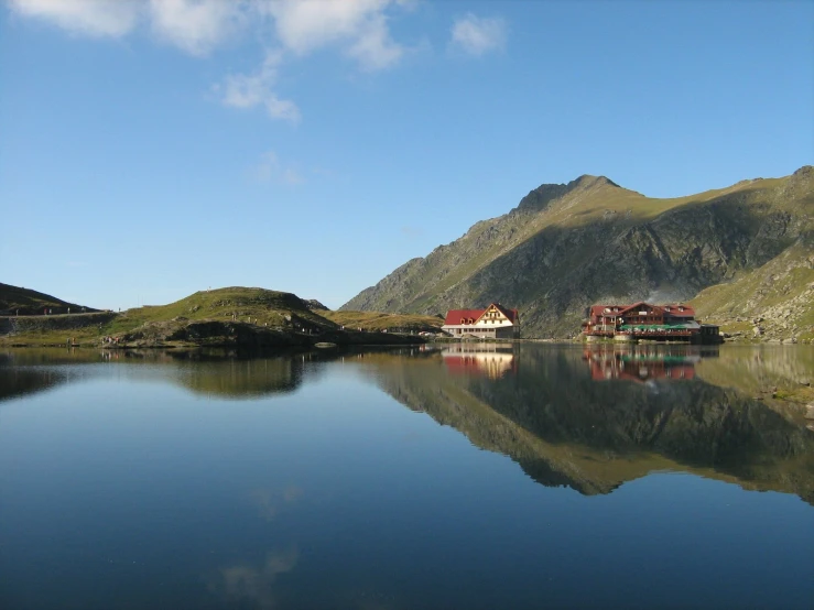 two houses on the shore of a mountain lake