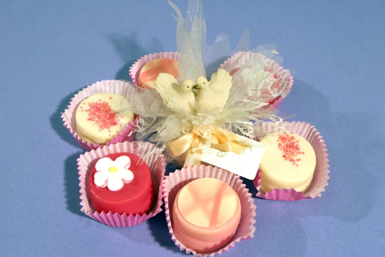 several small cupcakes in pink and white wrappers