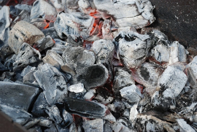 the charcoals are cooking and sitting on the grill