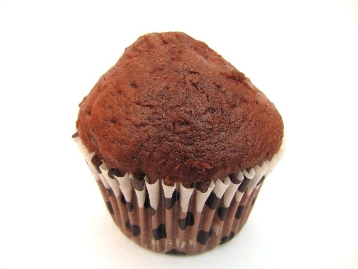 a chocolate cupcake sits in a white cupcake wrapper