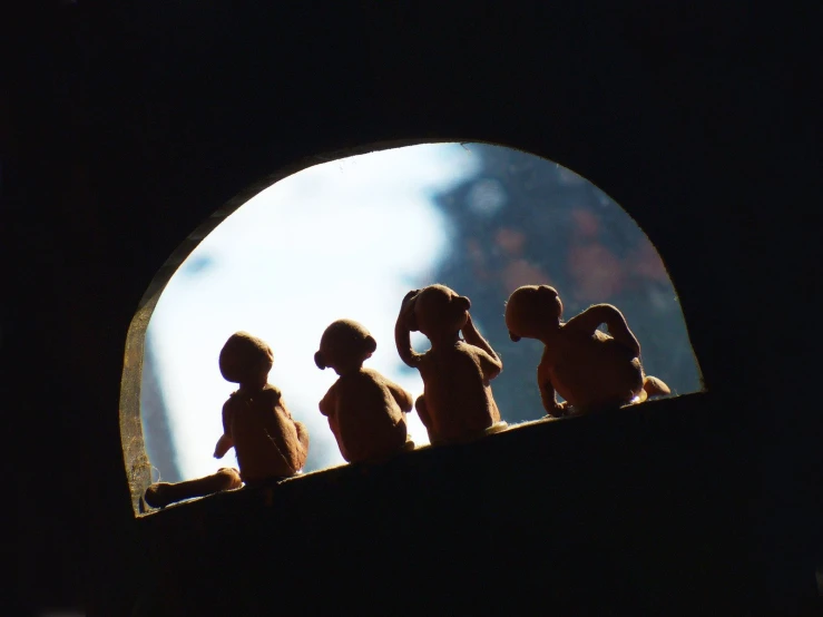 a group of stuffed animals standing on top of a shelf