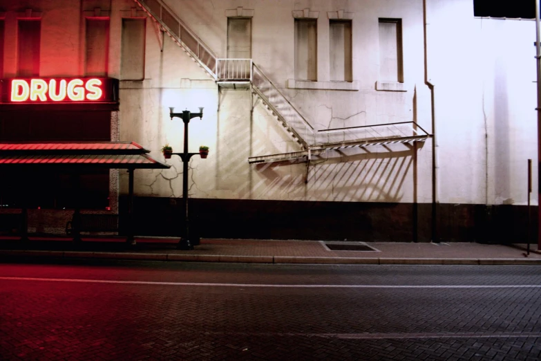 a red and yellow drags sign sitting next to a stairway