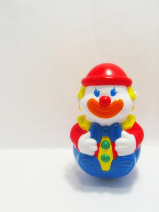 small plastic clown toy wearing a red helmet