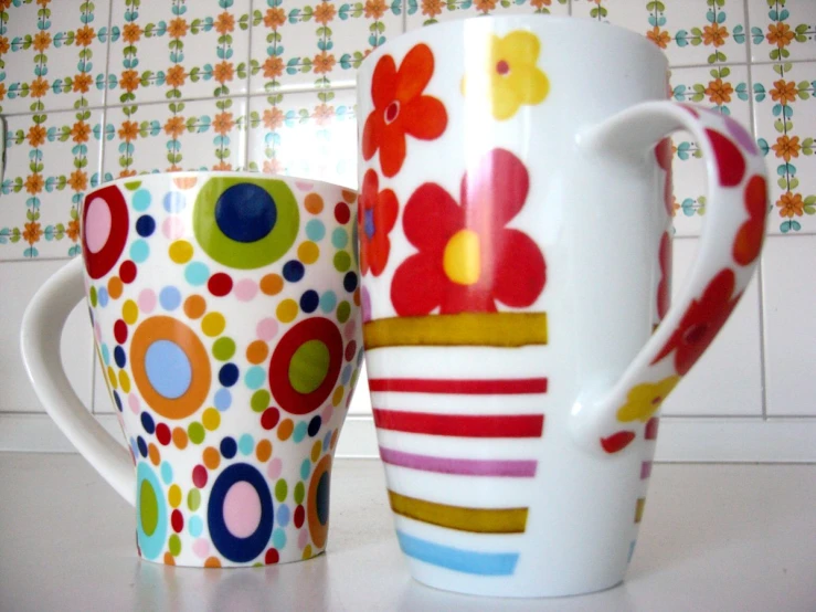 colorfully painted coffee mugs with different patterns and sizes