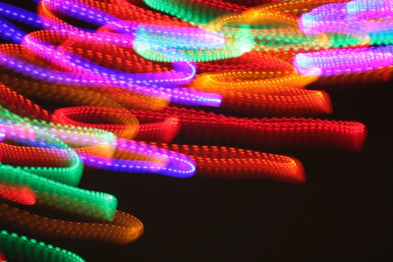 neon colored streamers against black background glowing