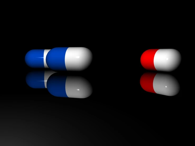 two pills with different colors sitting on top of each other