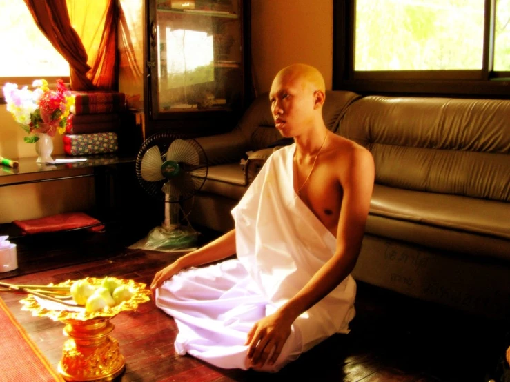 a man in white is sitting on the table