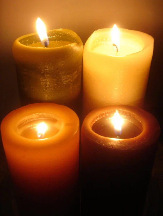 five glowing lit candles in an arrangement