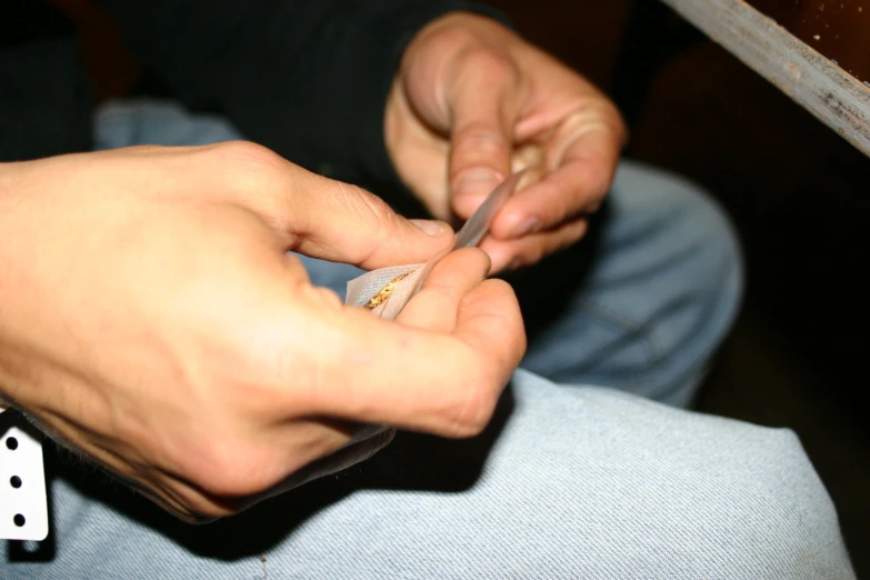 a man with blue jeans is holding a toothbrush