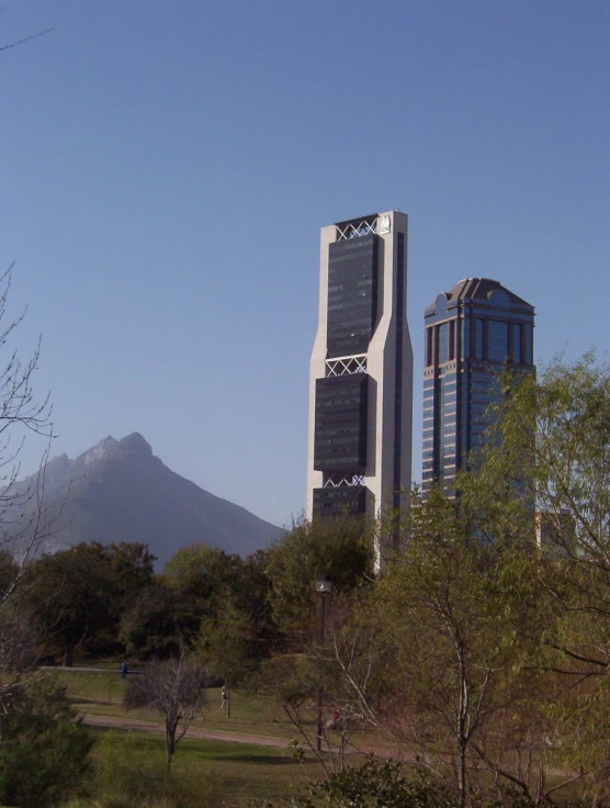 there are trees around a building next to mountains