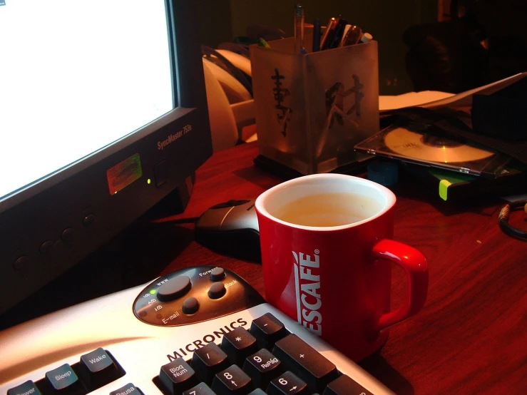 there is a coffee cup on a desk