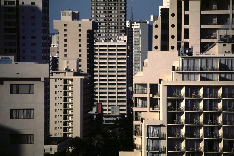 a view of some very tall buildings with their windows partially opened