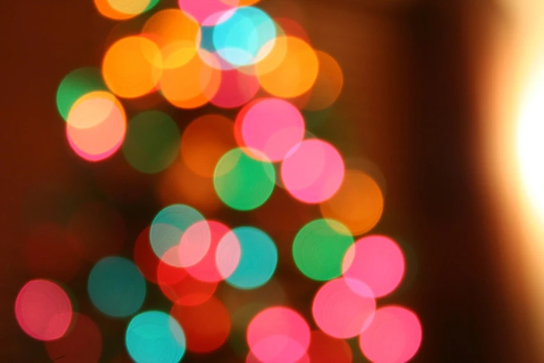 blurry image of deflated christmas tree with bright colored lights