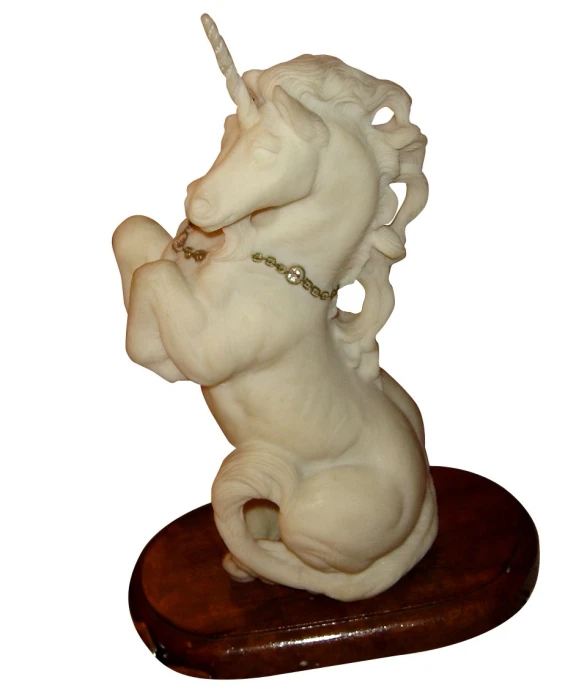 a white ceramic sculpture of a unicorn