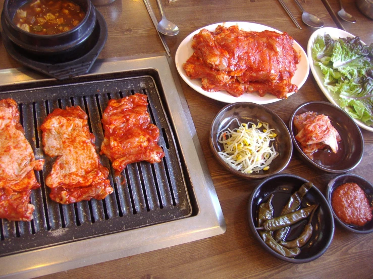 the meal is cooking on the grill over the table