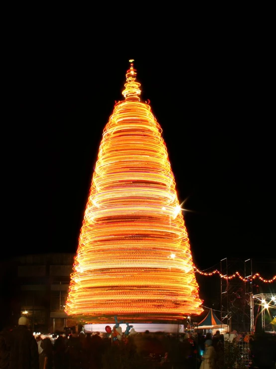 a bright lit christmas tree in front of an event