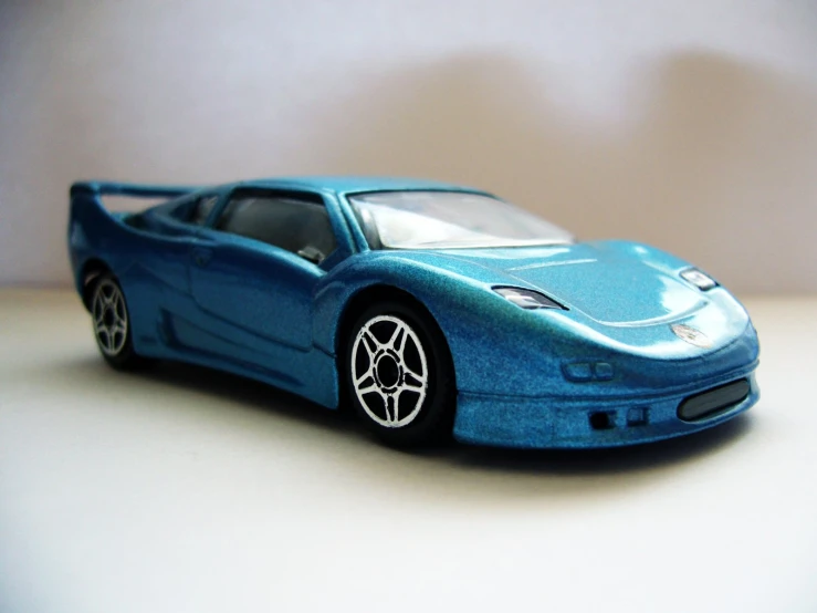a blue toy sports car is in the shape of a car