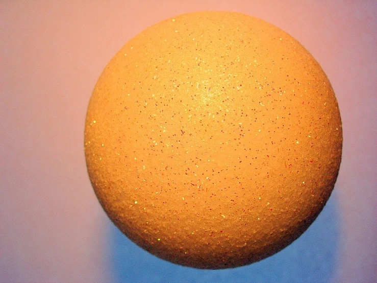 an orange with the light shining on it