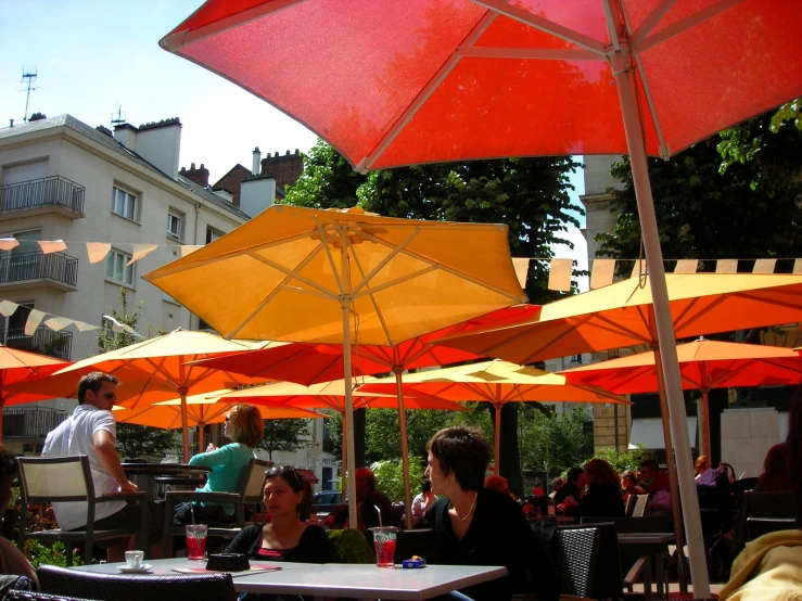 a dining area with several umbrellas that are open