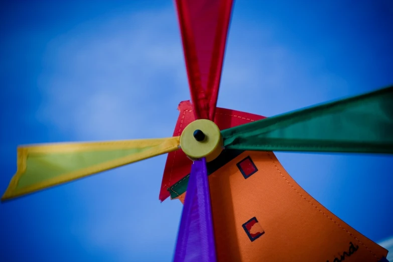 a colorful plastic fan with yellow, orange, and purple blades