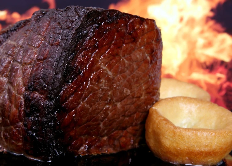 a piece of meat sitting next to two fried onions