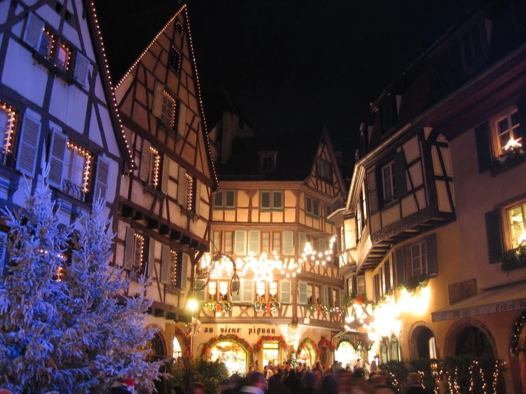 the street is decorated for the holidays with lit christmas decorations