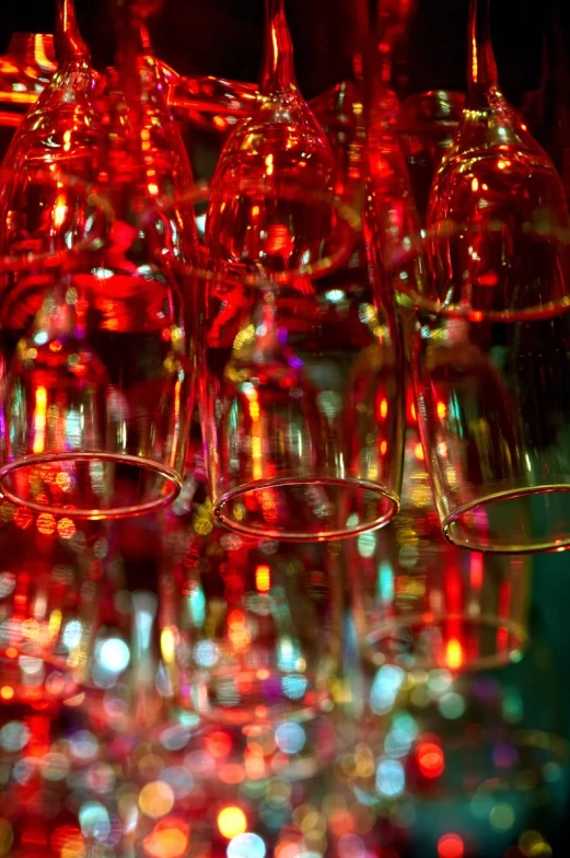 several wine glasses sit together against a black background