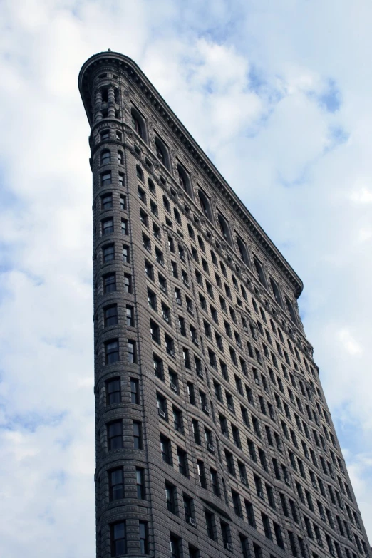 a tall building with lots of windows against a blue sky