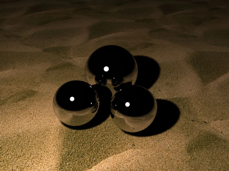 three black object that look like balls are next to each other