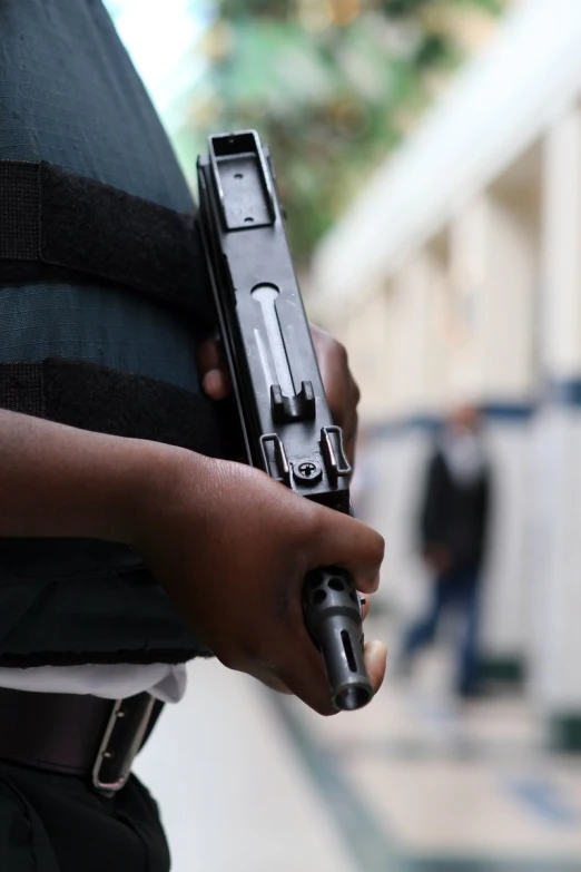 a person holding a gun and looking down