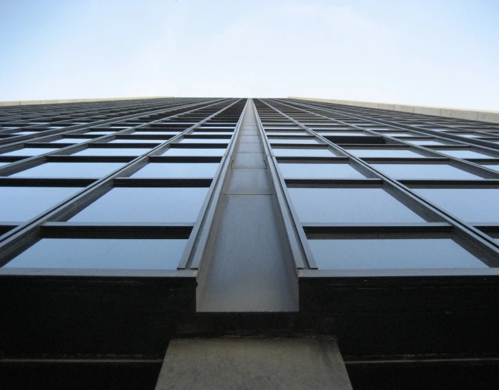 looking up at a large building with lots of windows