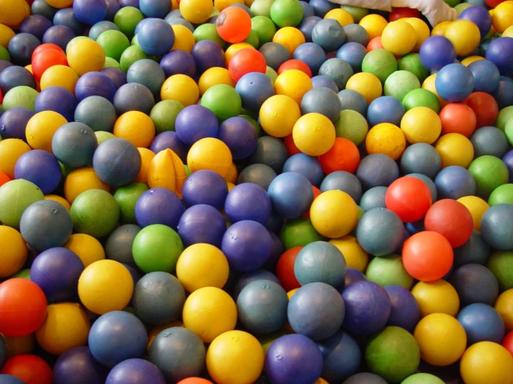 some balls and water toys are sitting in a pool