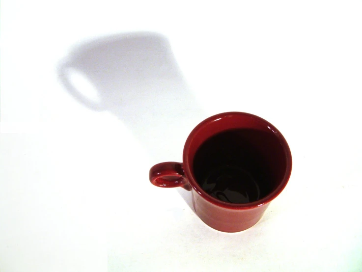 an empty cup of coffee sits on a white background