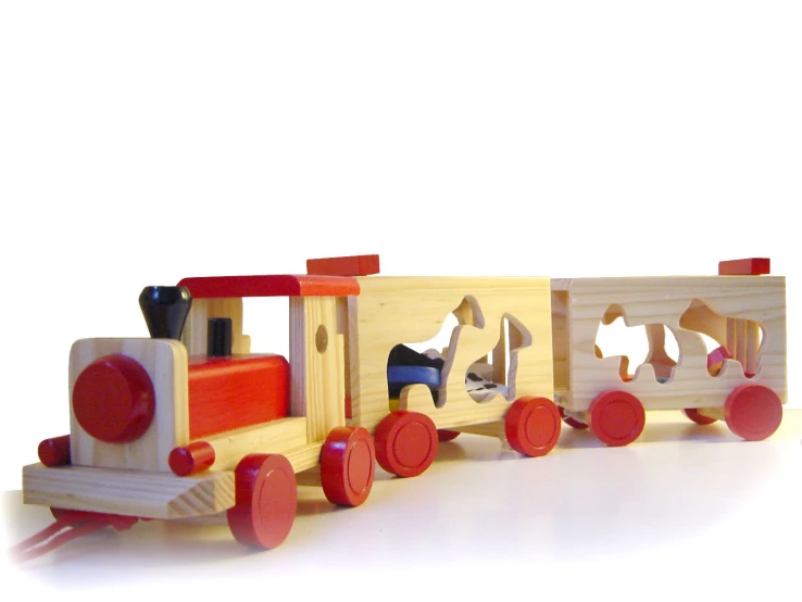 a wooden toy truck with two animals on it