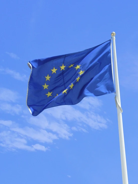 a flag is flying against the blue sky