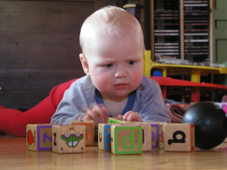 a baby playing with cubes of some sort