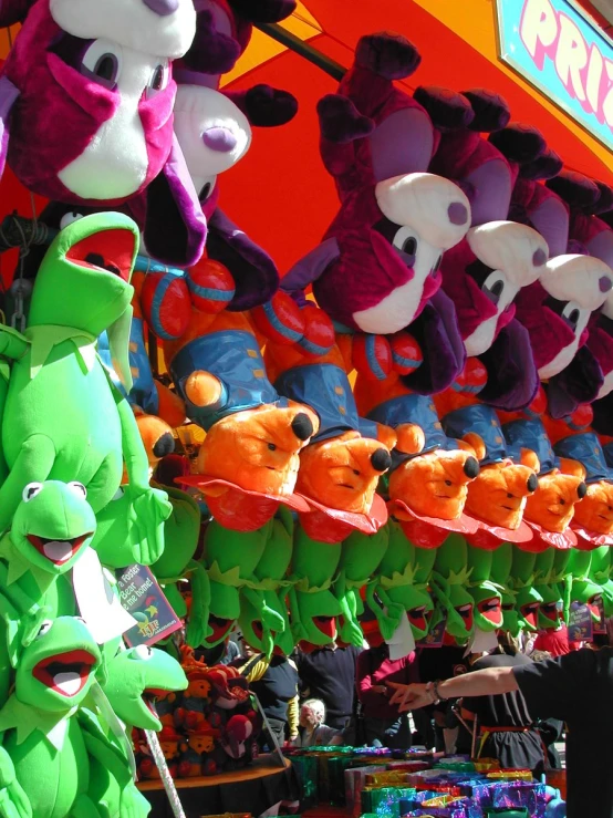 various stuffed animals in the shape of a cat and alligator