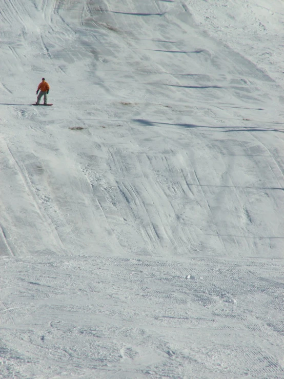 a person skiing on the side of a snowy hill