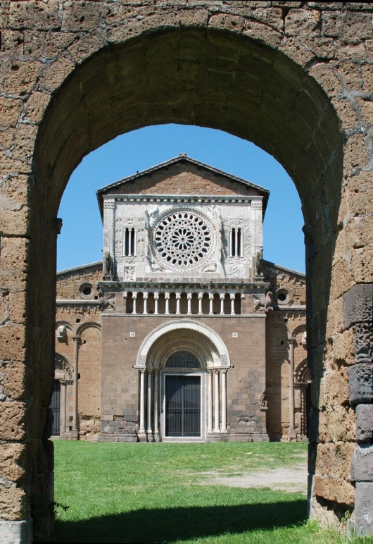 a large building with arches and a large clock tower