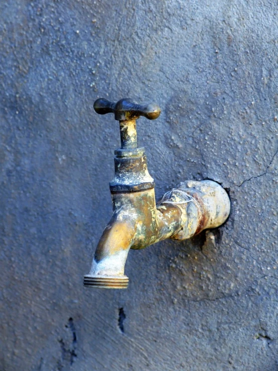 this is an image of a rusty faucet outside