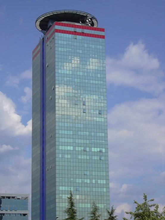 a building has windows and a cloudy sky