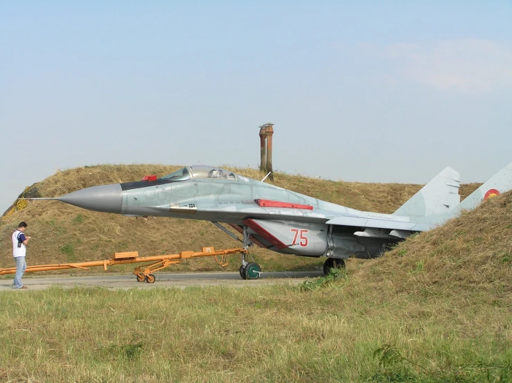 fighter jet sitting on top of an airport runway