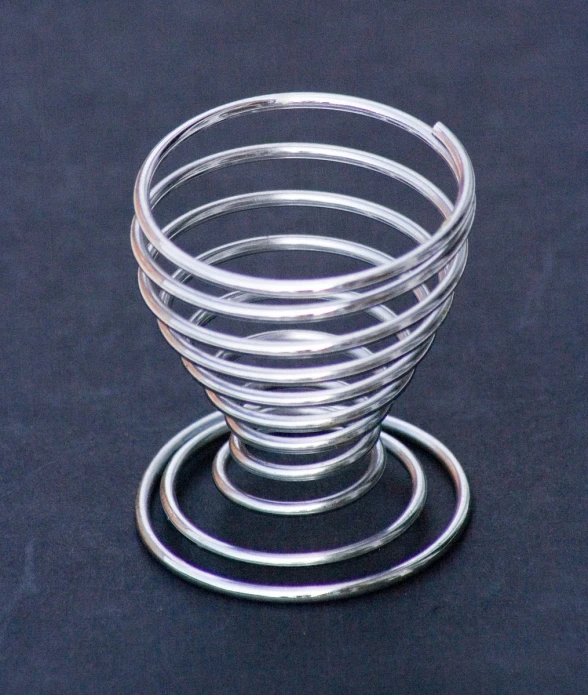 a spiraled glass on top of a black surface