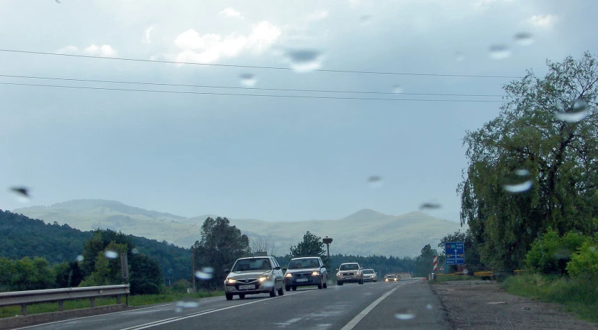 cars and trucks driving on a country road