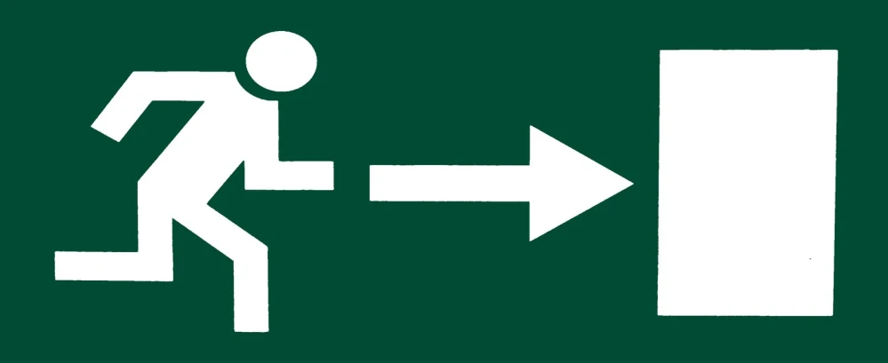 a sign pointing up at a white arrow