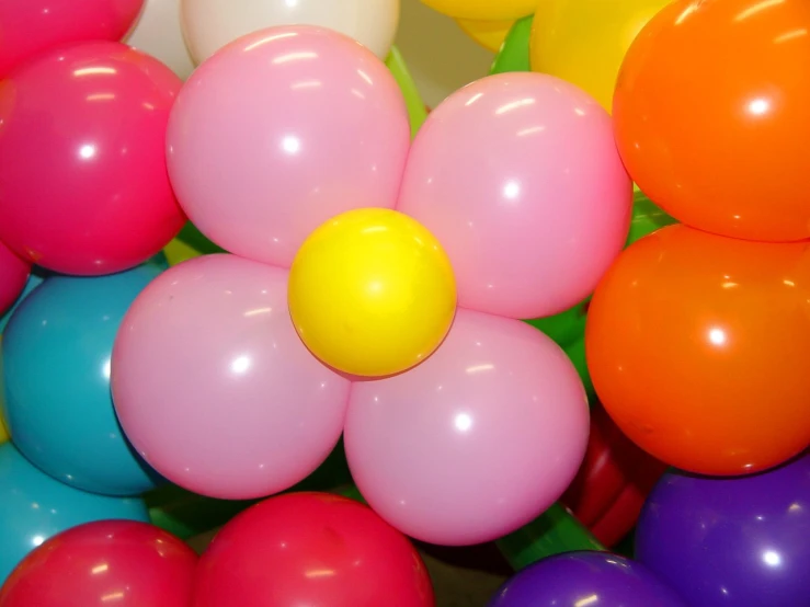 the rainbow balloons are scattered near each other