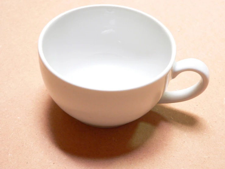 white cup on counter with orange light in background