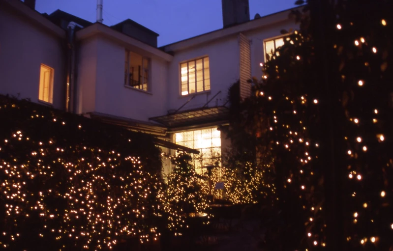 a group of lights sitting on top of a house's windows