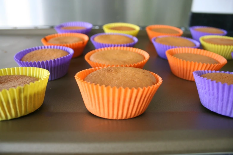 a close up of some colorful cupcakes with cake in them